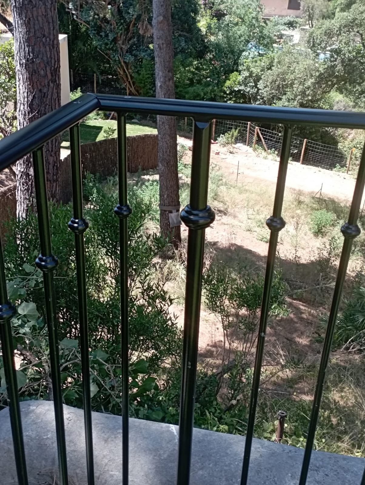 Angle de garde-corps noir sur terrasse ensoleillée
